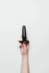 Black butt plug in a females hand